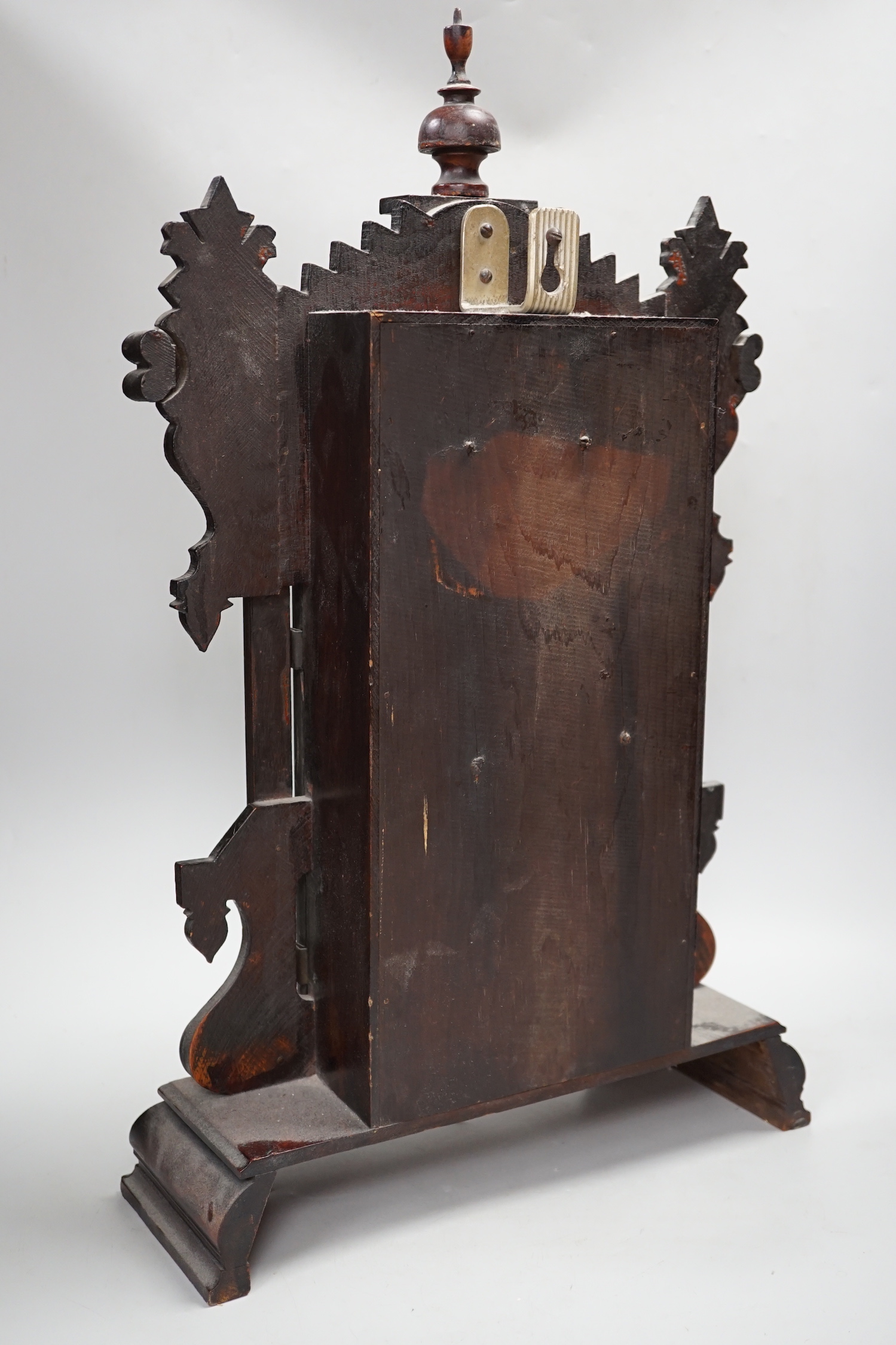 A 19th century American shelf clock, 60cm high, the glass decorated with the figure of the Statue of Liberty, 60cm high